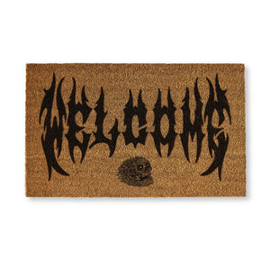 Doormat with 'Welcome' text and skull design on a white background
