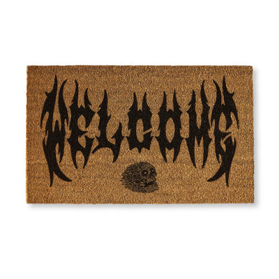 Doormat with 'Welcome' text and skull design on a white background