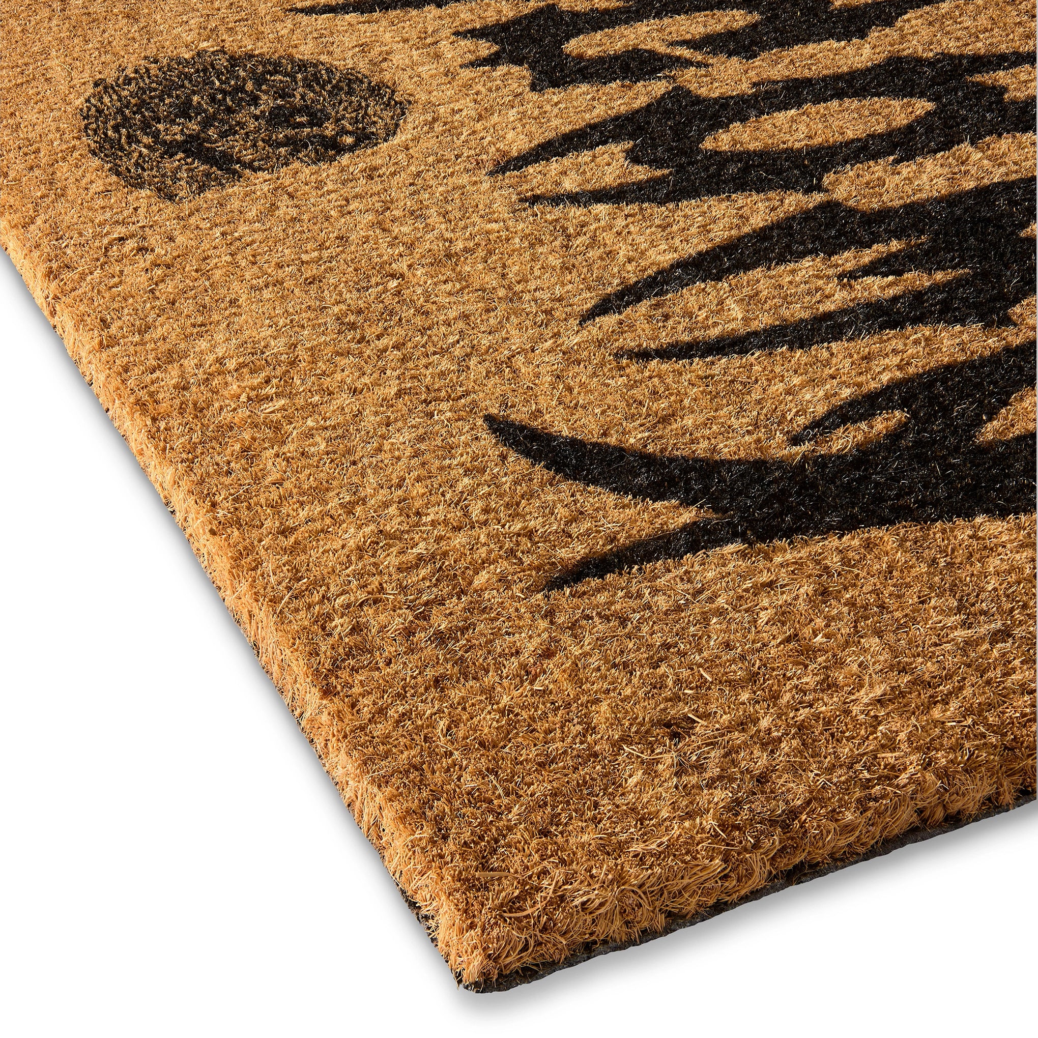 Doormat with black paw print design on a beige background