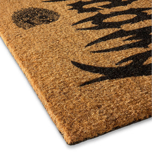 Doormat with black paw print design on a beige background