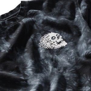 Black tie-dye shirt with a white embroidered design on a plain background