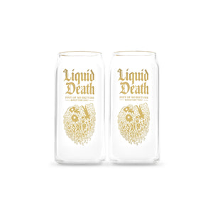 Two clear glasses with gold 'Liquid Death' text and skull design on a white background