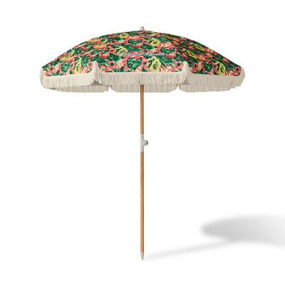 Tropical patterned beach umbrella with fringe on a white background