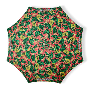 Umbrella with a colorful leaf pattern and 'Liquid Death' branding on a white background