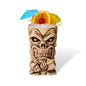Tiki mug with skull design filled with a tropical drink on a white background
