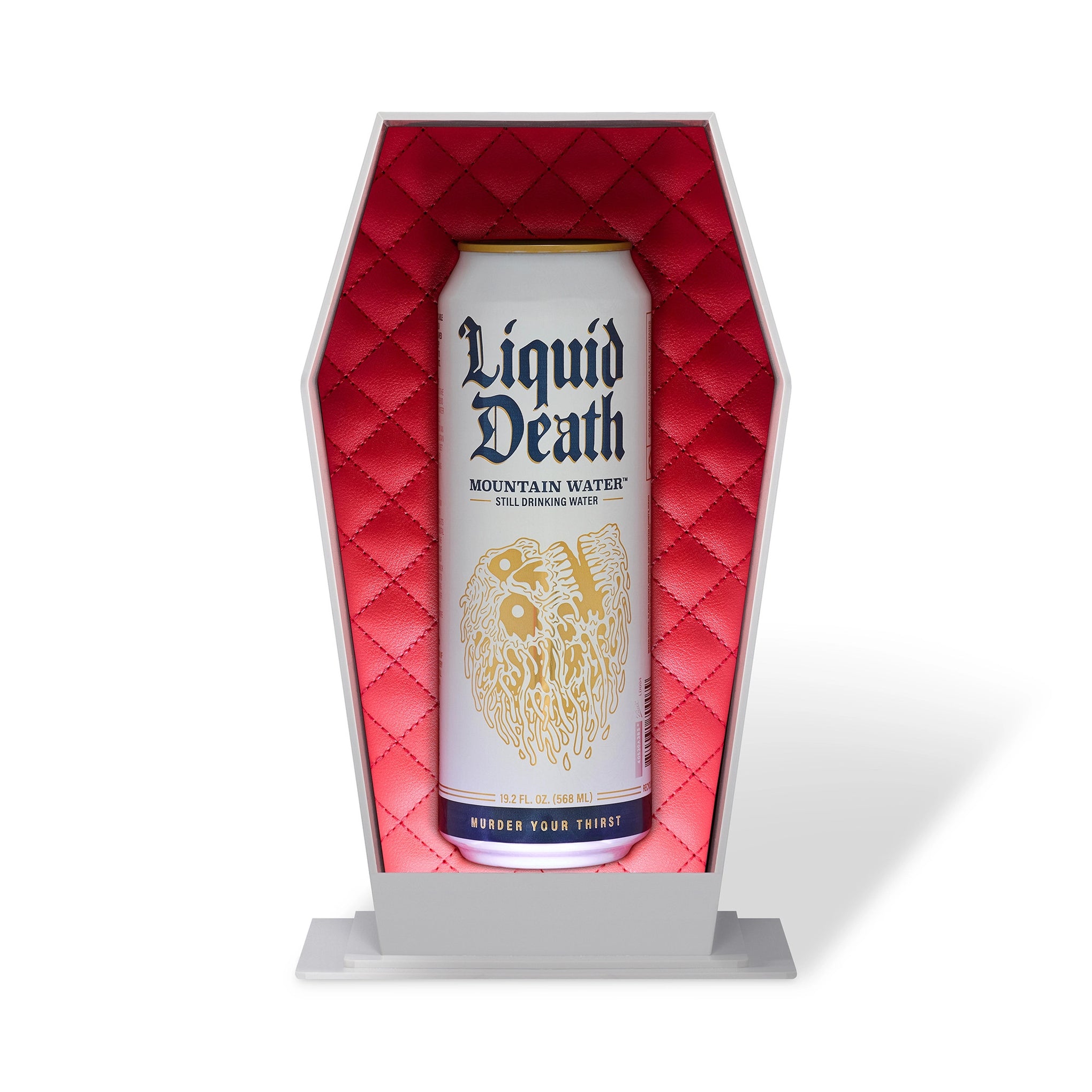 Can of 'Liquid Death' mountain water in a red coffin-shaped holder on a white background